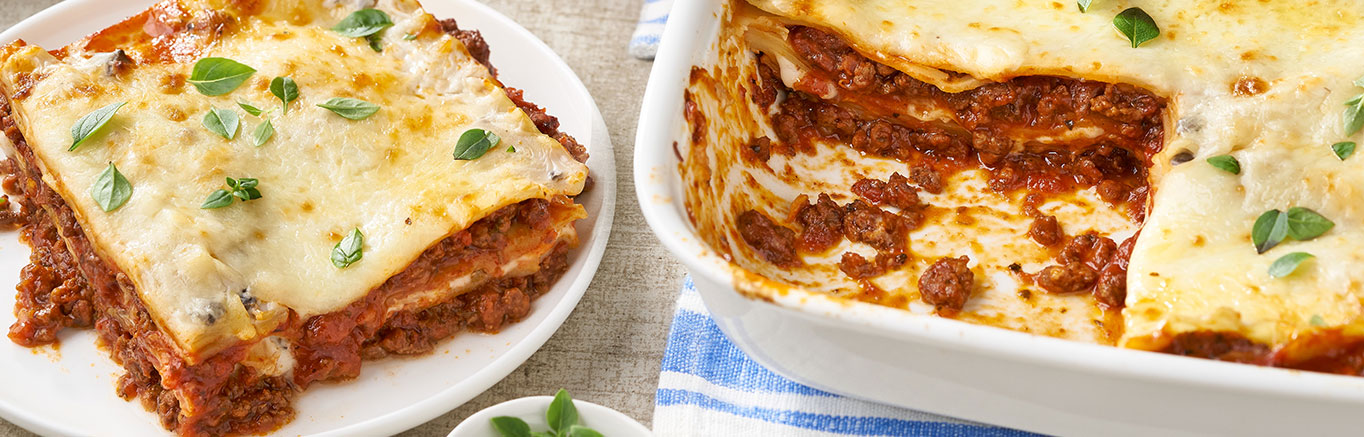 An image of prepared Easy Classic Beef Lasagna showing layers of lasagna noodles, ground beef, Prego® Fresh Mushroom Italian Sauce, Campbell's® Condensed Cream of Mushroom Soup and mozzarella cheese.