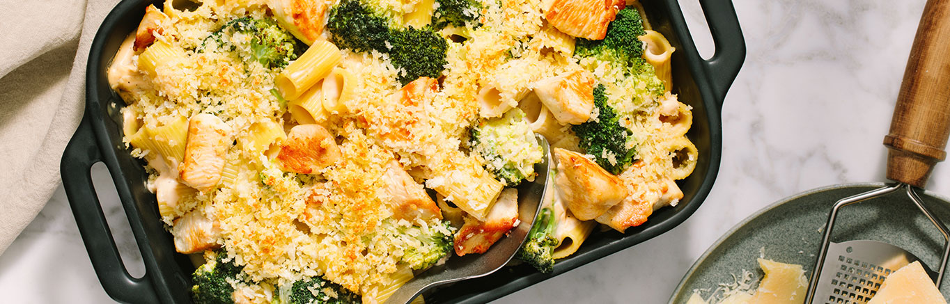 An image of prepared Chicken Broccoli Alfredo Bake made with Prego® Homestyle Alfredo Sauce, Parmesan cheese, chicken, penne pasta, broccoli and mozzarella cheese.