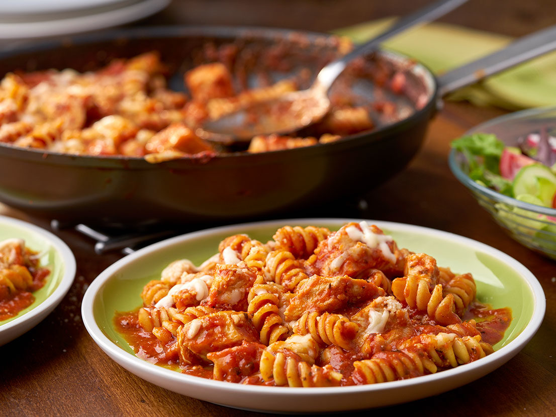 An image of prepared Easy Chicken Parmesan Pasta Skillet made with chicken, Prego® Traditional Italian Sauce, rotini pasta, Swanson® Natural Goodness® Chicken Broth, Parmesan cheese and mozzarella cheese.