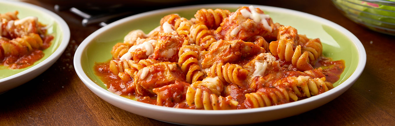 An image of prepared Easy Chicken Parmesan Pasta Skillet made with chicken, Prego® Traditional Italian Sauce, rotini pasta, Swanson® Natural Goodness® Chicken Broth, Parmesan cheese and mozzarella cheese.