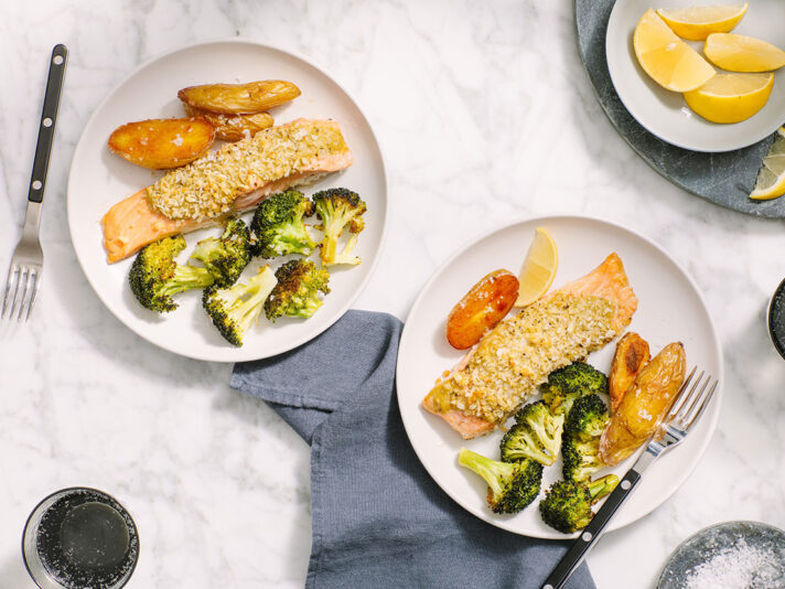 An image of prepared Parmesan-Crusted Pesto Salmon made with Yukon Gold potatoes, broccoli, salmon and Prego® Creamy Roasted Garlic Pesto Sauce.