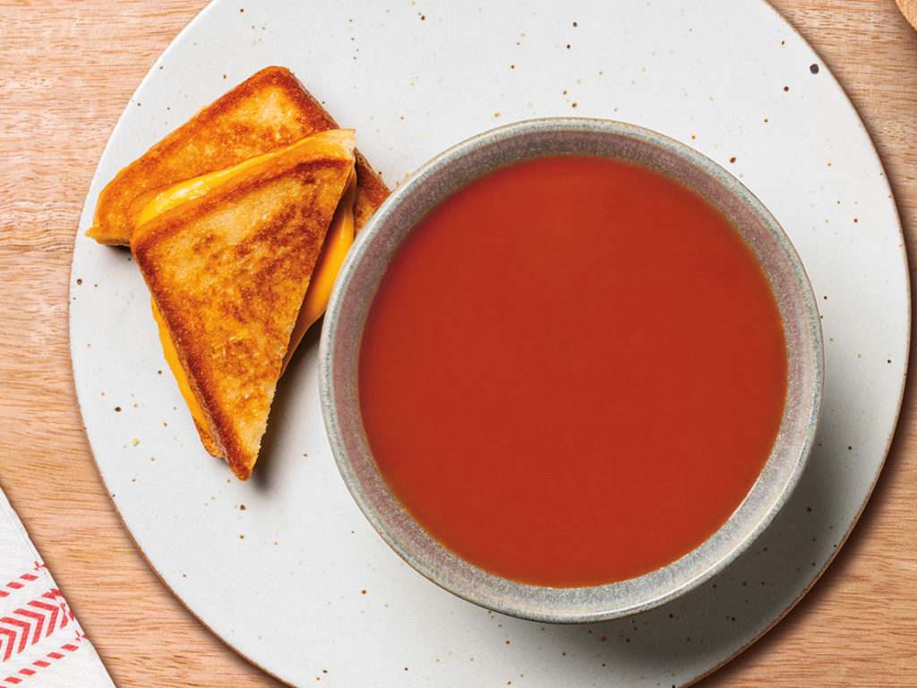 An image of prepared Tomato Soup & Grilled Cheese Sandwich made with Campbell's® Condensed Tomato Soup, Pepperidge Farm® Farmhouse™ Hearty White Bread and KRAFT American Cheese Slices.